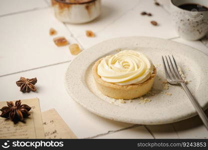 Mini tart with whipped cream and lemon, sweet dessert on white plate. Mini tart with whipped cream