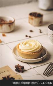 Mini tart with whipped cream and lemon, sweet dessert on white plate. Mini tart with whipped cream