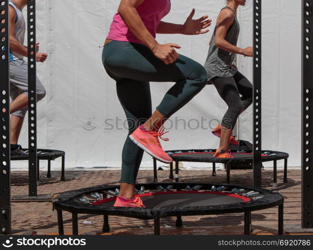 Mini Trampoline Workout: Girl doing Fitness Exercise in Class at Gym