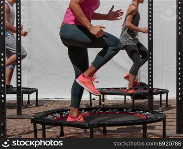 Mini Trampoline Workout: Girl doing Fitness Exercise in Class at Gym