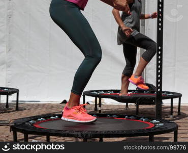 Mini Trampoline Workout: Girl doing Fitness Exercise in Class at Gym