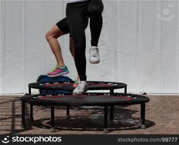 Mini Trampoline Workout: Girl doing Fitness Exercise in Class at Gym