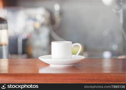 Mini white coffee cup in coffee shop, stock photo