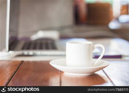 Mini white coffee cup on work station, stock photo
