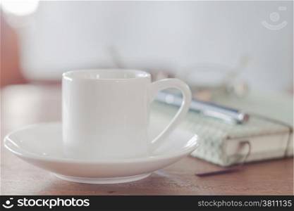 Mini white coffee cup with notebook, stock photo