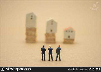 Miniature 3 people businessmen standing with back Negotiating in business. as background business concept and strategy concept with copy space.