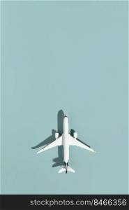 Miniature airplane on blue background with copy space. ravel, vacations, tourism, airlines, low cost flights concept. Top view, flat lay.