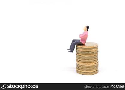 Miniature businessman and coins on white background