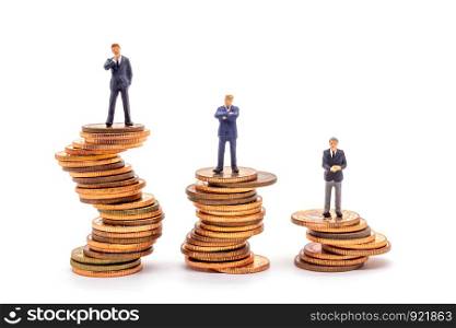 Miniature businessman on stack on white background. Concept uncertainty business market.