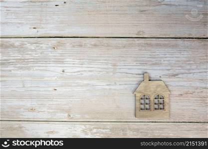 Miniature house on wooden background. Top view. Buy of property, home, real estate. affordable housing. advantageous offer from the bank copy space space for text. Miniature house on wooden background. Top view. Buy of property, home, real estate. affordable housing. advantageous offer from the bank copy space