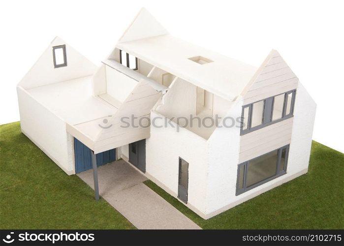 Miniature house with furniture isolated over white background