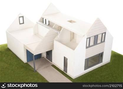 Miniature house with furniture isolated over white background