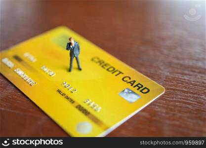 Miniature people businessmen standing on Credit Cards model using as background business concept and finance concept with copy space for your text or design.