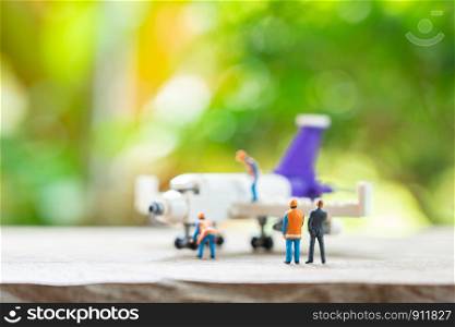 Miniature people Construction worker mechanical engineer Repair. using as background concept of engine maintenance Travel safely with copy spaces.