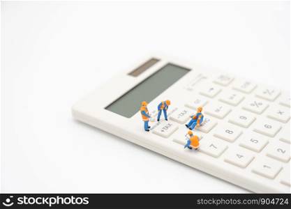 Miniature people Pay queue Annual income (TAX) for the year on calculator. using as background business concept and finance concept with copy space for your text or design.