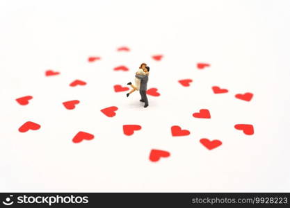 Miniature people standing with Heart shaped red paper. Red heart is the promise of love.  as background Valentine concept with copy spaces for your text or design.