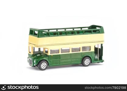 miniature scale model of a vintage open-top tour bus on white