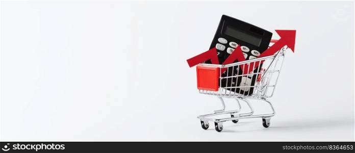 Miniature Shopping cart trolley, calculator and red arrow up on white background with copy space. Concept for grocery expenses and consumerism