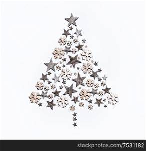 Minimal Christmas tree composition made with stars and snowflakes on white background. Top view. Creative winter holiday concept. Greeting card layout