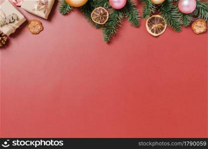 Minimal creative flat lay of christmas traditional composition and new year holiday season. Top view winter christmas decorations on red background with blank space for text. Copy space photography.