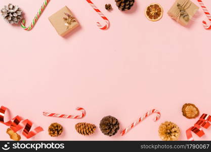 Minimal creative flat lay of christmas traditional composition and new year holiday season. Top view winter christmas decorations on pink background with blank space for text. Copy space photography.