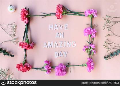 Minimal flat lay you are amazing inspiration wooden word with fresh flowers frame