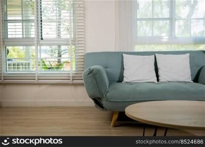 Minimal living room interior with comfortable modern green sofa near window at home sunny day, Apartment furnished empty white wall