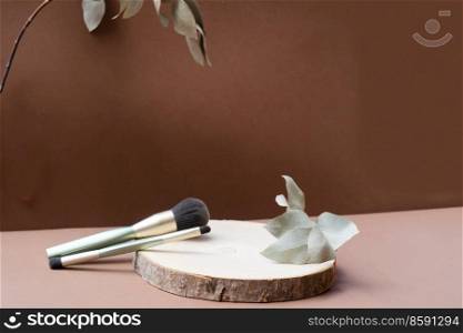 Minimal modern cosmetic products display make up brushes on natural earth tones background. Minimal product display
