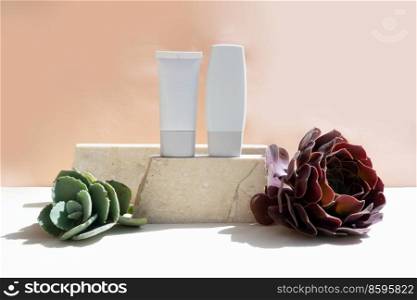 Minimal modern cosmetic products display with two tubes on beige background with succulent. Minimal product display