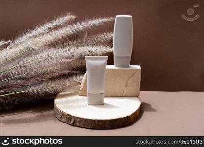 Minimal modern cosmetic products display with two tubes on natural earth tones background with shadow overlay. Minimal product display