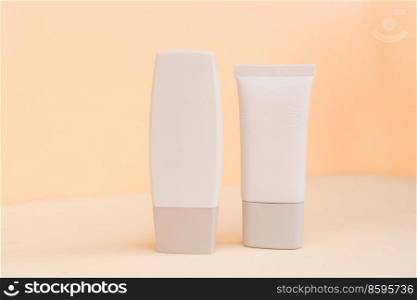 Minimal modern cosmetic products display with two tubes on textured beige background with shadow overlay. Minimal product display