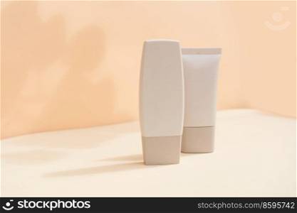 Minimal modern cosmetic products display with two tubes on textured beige background with shadow overlay. Minimal product display