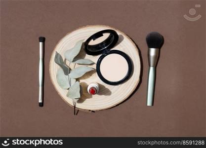 Minimal modern cosmetic scene with make up brushes, powder and eucaliptus leaves. make up scene