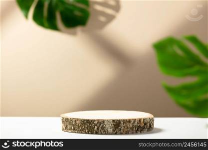 Minimal modern product display on neutral beige background. Wood slice podium and green monstera leaves. Concept scene stage showcase for new product, promotion sale, banner, presentation, cosmetic