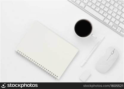 Minimal Office desk table top view with notebook blank pages, Keyboard computer, mouse, coffee cup on a white table with copy space, White color workplace composition, flat lay