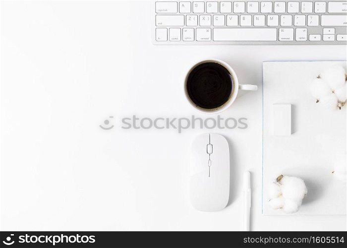 Minimal Office desk table with Keyboard computer, coffee cup, mouse, white pen, cotton flowers, eraser on a white table with copy space for input your text, White color workplace composition, flat lay, top view