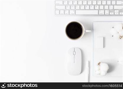 Minimal Office desk table with Keyboard computer, coffee cup, mouse, white pen, cotton flowers, eraser on a white table with copy space for input your text, White color workplace composition, flat lay, top view