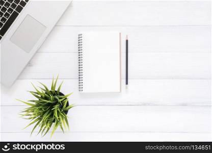 Minimal work space - Creative flat lay photo of workspace desk. Top view office desk with laptop, mock up notebooks and plant on white wooden background. Top view with copy space, flat lay photography