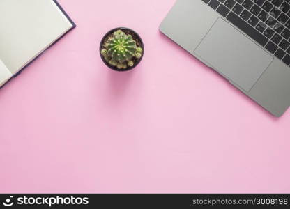 Minimal work space - Creative flat lay photo of workspace desk. Top view office desk with laptop, notebooks and plant copy space on color background. Top view with copy space, flat lay photography.