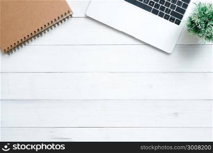 Minimal work space - Creative flat lay photo of workspace desk. Top view office desk with laptop, mock up notebooks and plant on white wooden background. Top view with copy space, flat lay photography