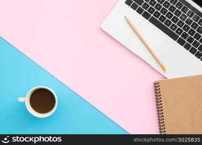 Minimal work space - Creative flat lay photo of workspace desk. Top view office desk with laptop, notebooks and coffee cup on pastel color background. Top view with copy space, flat lay photography.