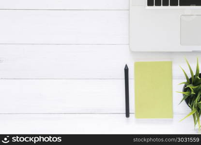Minimal work space - Creative flat lay photo of workspace desk. . Minimal work space - Creative flat lay photo of workspace desk. Top view office desk with laptop, mock up notebooks and plant on white wooden background. Top view with copy space, flat lay photography