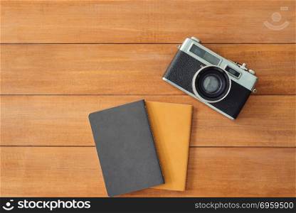 Minimal work space - Creative flat lay photo of workspace desk. . Minimal work space - Creative flat lay photo of workspace desk. Office desk wooden table background with mock up notebooks and retro camera. Top view with copy space, flat lay photography