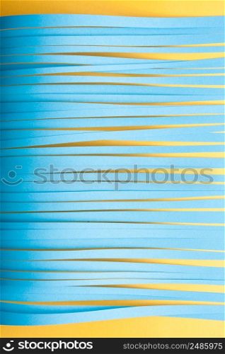 Minimalist cut paper stips background in blue and yellow colors.