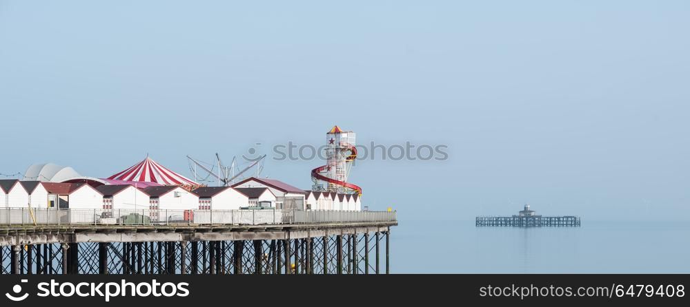 Minimalist fine art panoramic landscape image of colorful pier i. Minimalist fine art panorama image of colorful pier in juxtaposition with old derelict pier in background