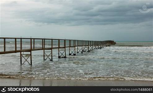 Minimalist seascape with the sea and perspective of long pier