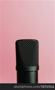 Minimalistic image of a streaming microphone over an pastel pink background with copy space, minimal concept, technology streaming