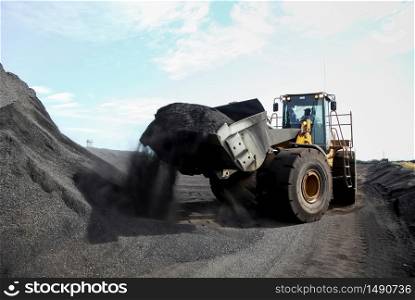 Mining front end loader transporting Manganese ore for processing and storage