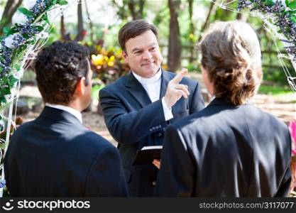 Minister blessing a gay couple while performing their wedding ceremony.