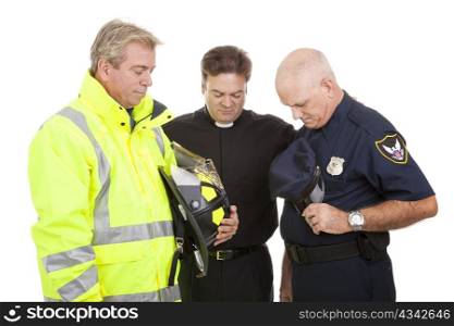 Minister prays with a firefighter and police officer at work. Isolated on white.